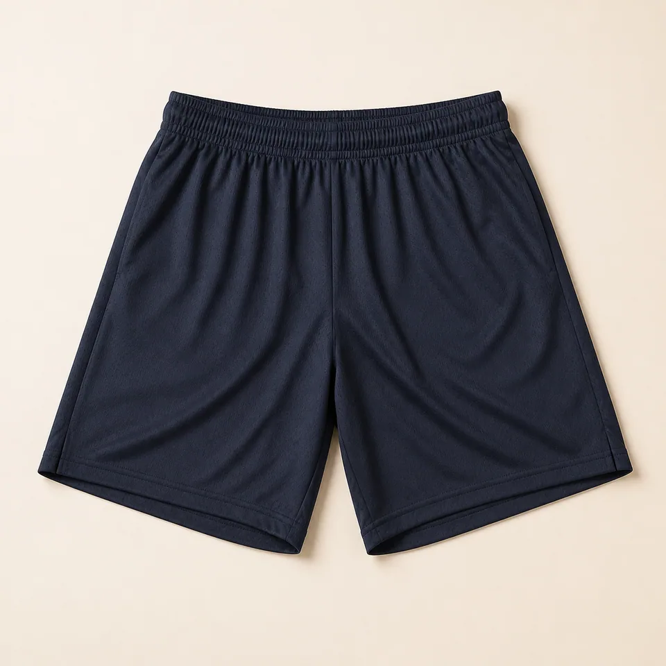 Navy performance team shorts shown fully on a warm studio background